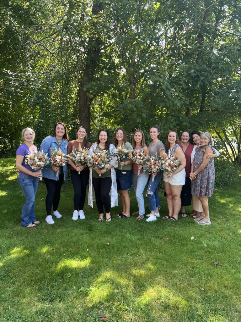 Bride and her friends and family and the wood flower wedding arrangements they made in Coventry CT