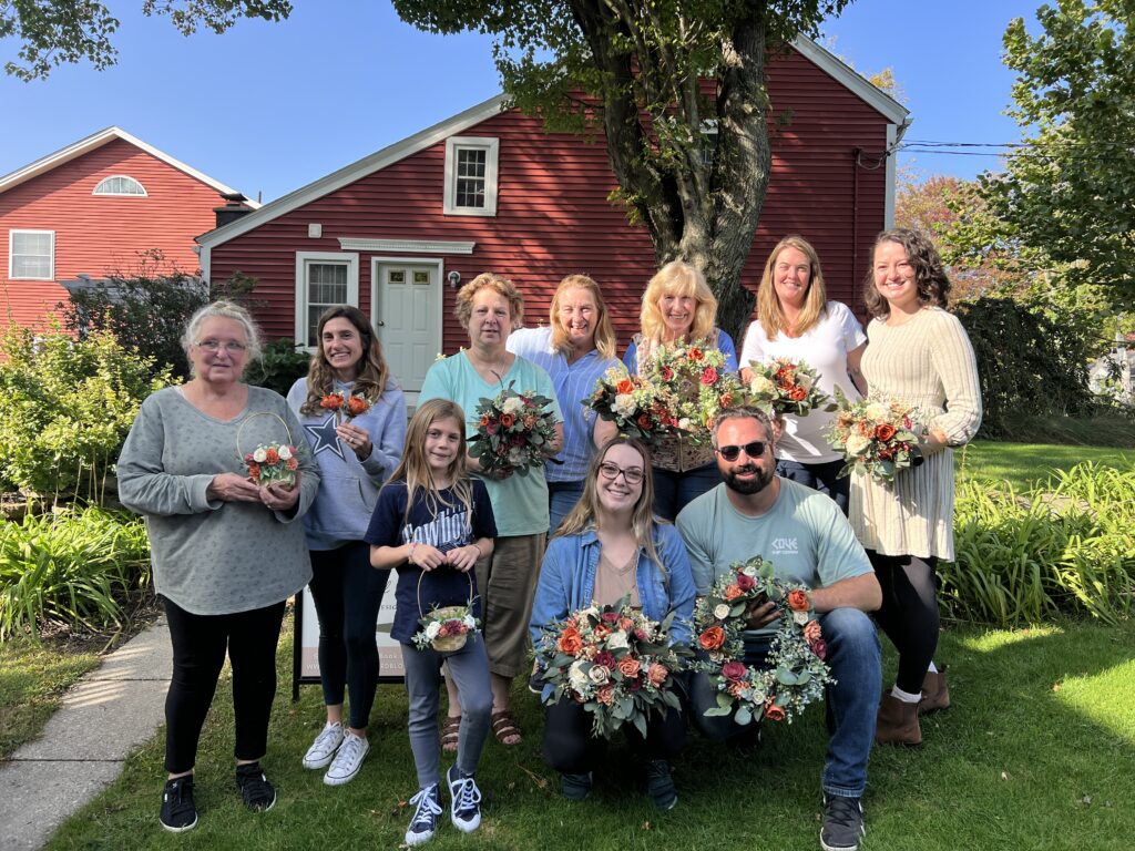 happy family posing with their DIY wood flower wedding florals