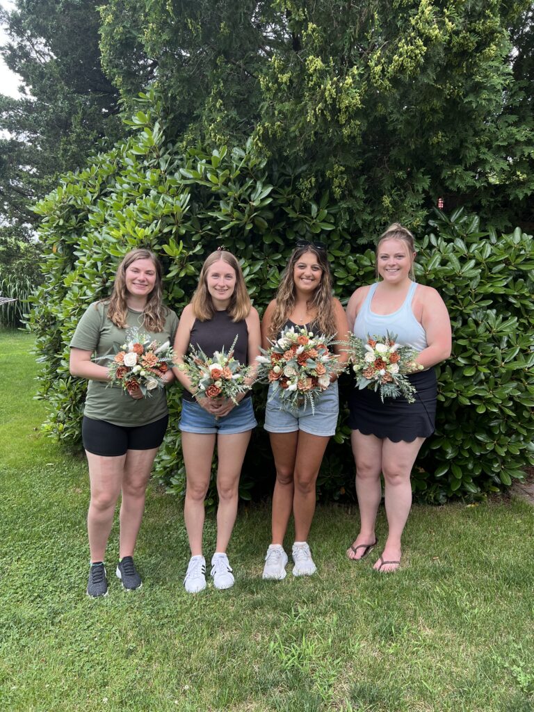 Bride and her friends and family and the wood flower wedding arrangements they made in Coventry CT